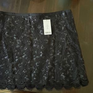Never worn, with tags.  Theory mini skirt, cotton appliqué over dark gray slip…